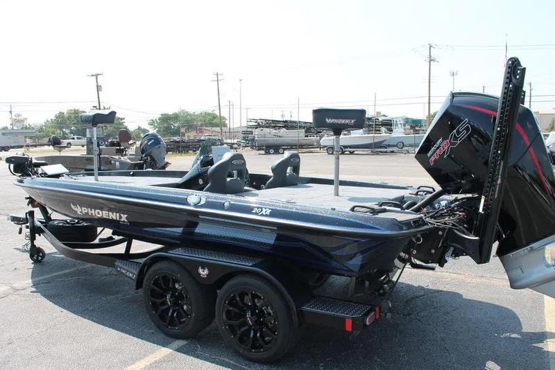 Slide: The Image of 2026 Phoenix 20 XE boat with powerful engine, sleek design, and dual seats in a parking lot. - 7