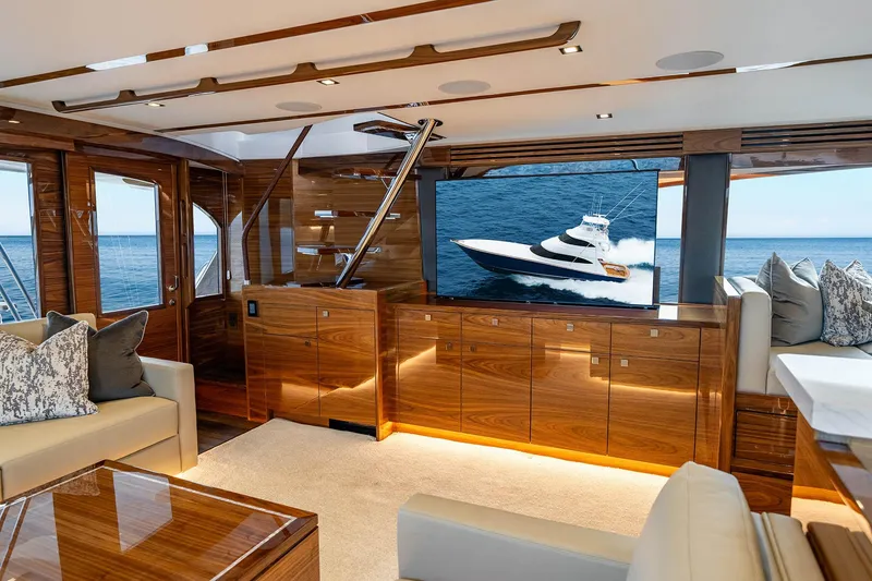 Slide: The Image of Luxurious interior of 2027 Viking 82 Skybridge yacht with elegant wood finishes and ocean view. - 10