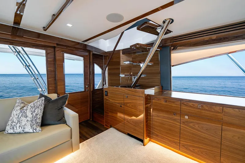 Slide: The Image of Luxurious interior of 2027 Viking 82 Skybridge yacht with ocean view and elegant wood finishes. - 12