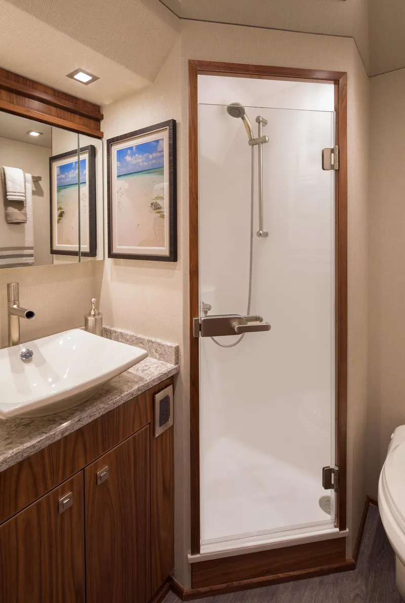 Slide: The Image of Luxurious bathroom in 2027 Viking 82 Skybridge yacht with modern shower and elegant sink. - 13
