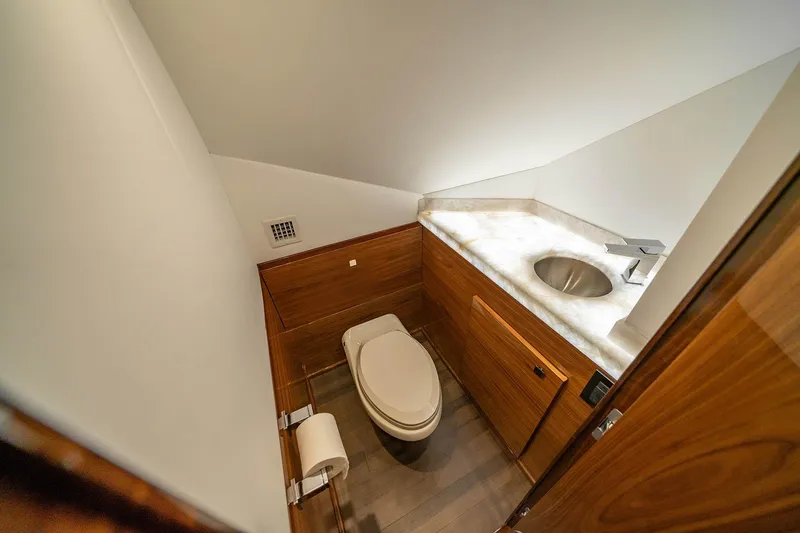 Slide: The Image of Luxurious bathroom in 2027 Viking 82 Skybridge yacht with modern fixtures and wood accents. - 15