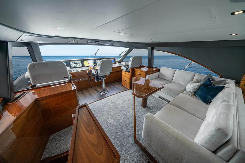 Slide: The Image of Luxurious interior of 2027 Viking 82 Skybridge yacht with plush seating and ocean view. - 17