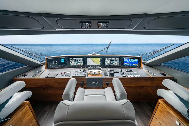 Slide: The Image of Luxurious 2027 Viking 82 Skybridge yacht helm with advanced navigation systems and ocean view. - 19