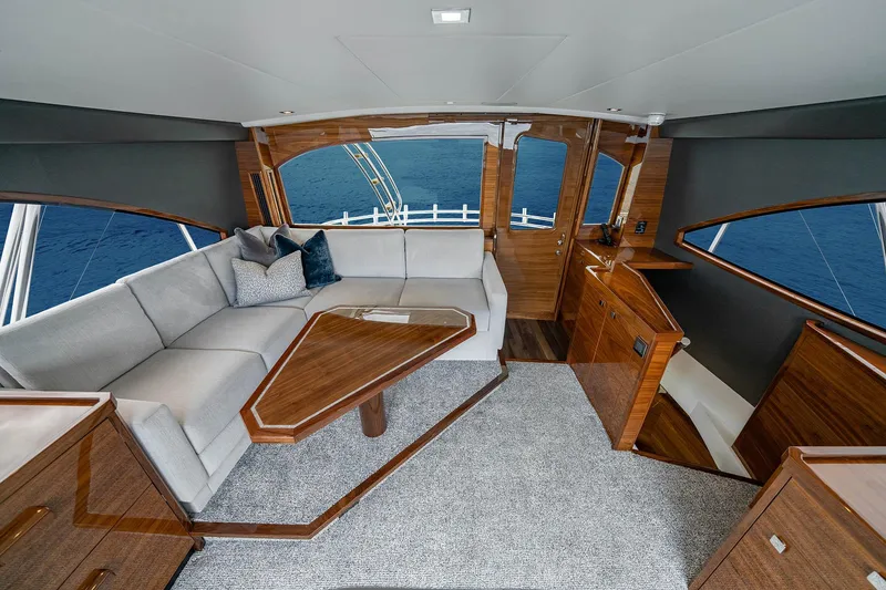 Slide: The Image of Luxurious interior of 2027 Viking 82 Skybridge yacht with elegant wood finishes and ocean view. - 21