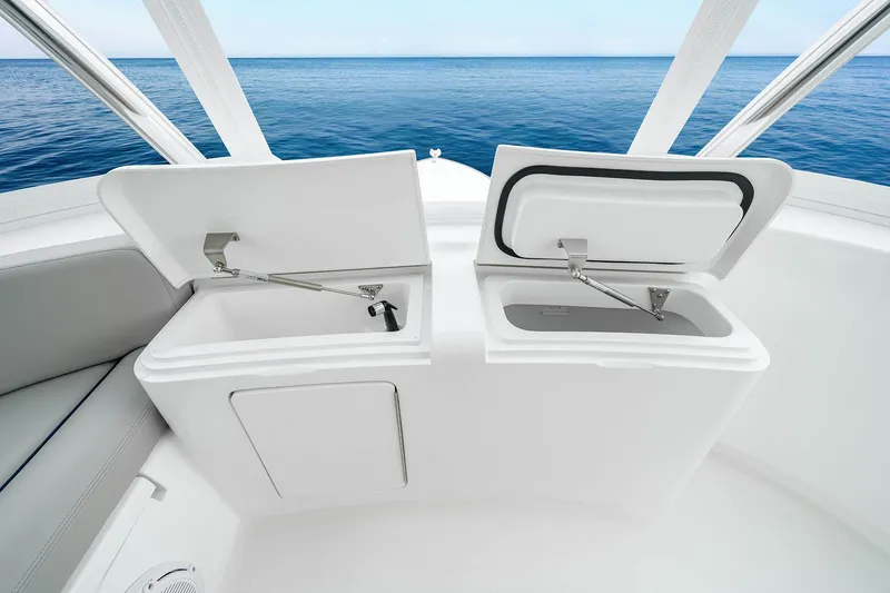 Slide: The Image of Open storage compartments on 2027 Viking 82 Skybridge yacht, overlooking the ocean. - 26