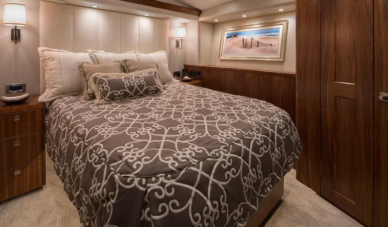 Slide: The Image of Luxurious bedroom interior of 2027 Viking 82 Skybridge yacht with elegant bedding and wood accents. - 7