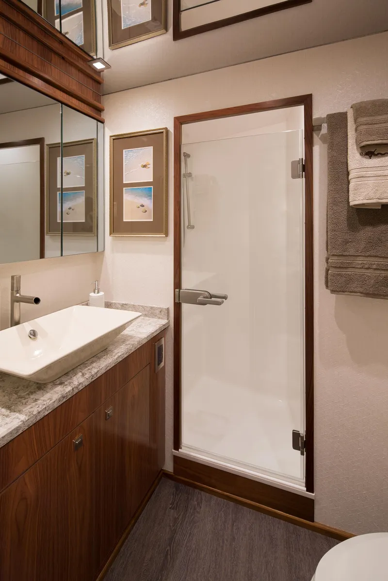 Slide: The Image of Luxurious bathroom in 2027 Viking 82 Skybridge yacht with modern sink and shower. - 9