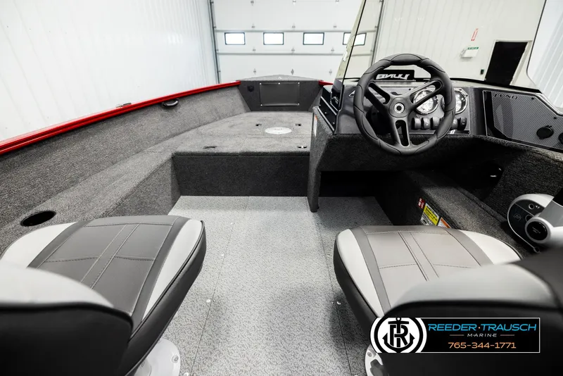 Slide: The Image of 2026 Lund 1650 Rebel XL SS boat interior with steering wheel and seating. - 11