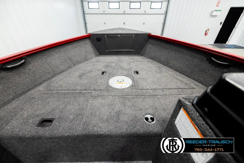 Slide: The Image of 2026 Lund 1650 Rebel XL SS boat interior with gray carpet and red trim. - 12