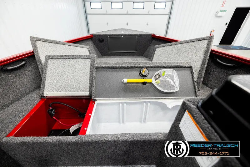 Slide: The Image of 2026 Lund 1650 Rebel XL SS boat interior with storage compartments and fishing net. - 13