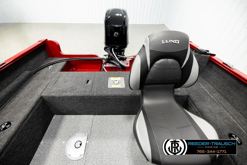 Slide: The Image of 2026 Lund 1650 Rebel XL SS boat interior with motor and seating. - 16