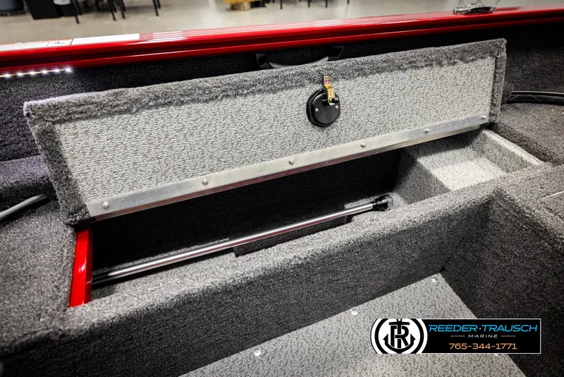 Slide: The Image of 2026 Lund 1650 Rebel XL SS boat interior storage compartment with carpeted finish and hydraulic lift. - 18