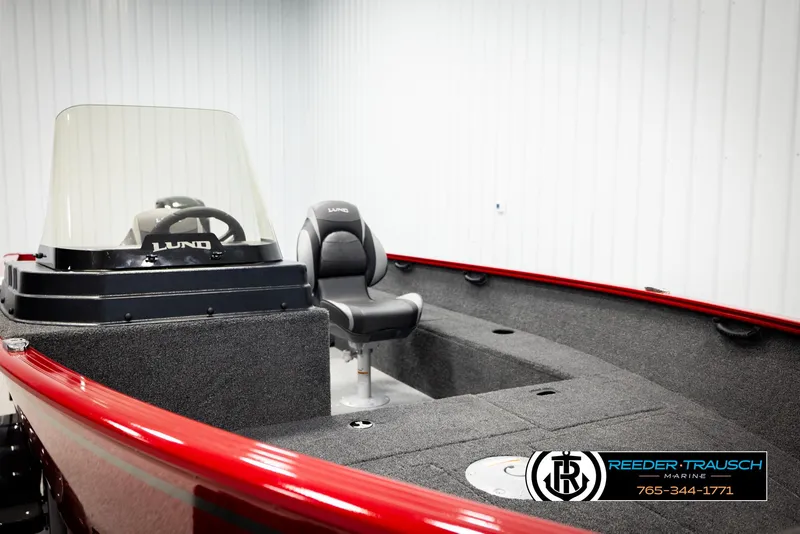 Slide: The Image of 2026 Lund 1650 Rebel XL SS boat interior with steering console and seating. - 23