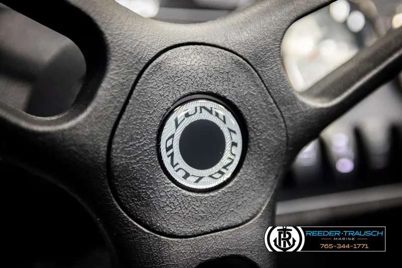 Slide: The Image of Steering wheel of 2026 Lund 1650 Rebel XL SS boat, featuring textured grip and logo. - 29