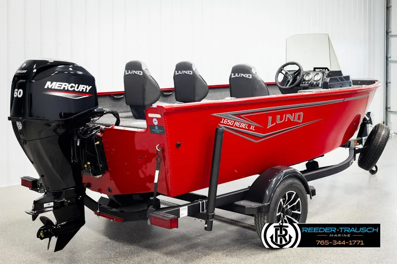 Slide: The Image of 2026 Lund 1650 Rebel XL SS boat with Mercury engine, red exterior, displayed indoors. - 3