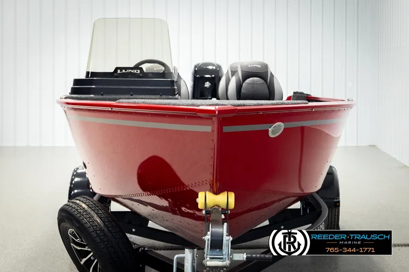 Slide: The Image of 2026 Lund 1650 Rebel XL SS boat in showroom, red exterior, on trailer. - 5