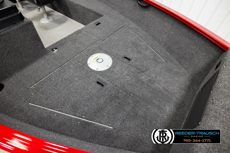 Slide: The Image of 2026 Lund 1650 Rebel XL SS boat interior with carpeted deck and storage compartments. - 6