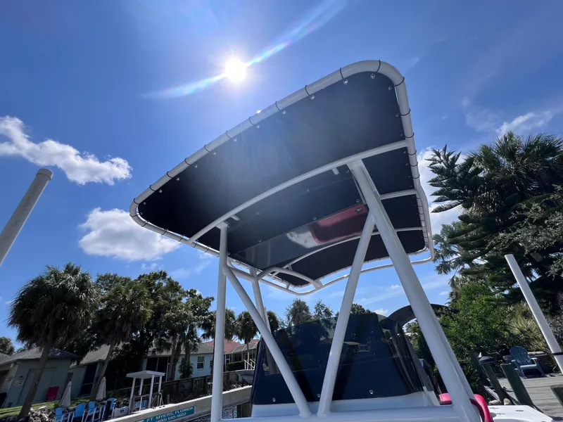 Slide: The Image of Boat canopy under sunny sky, Concept 23 model, 2000, with palm trees in the background. - 20