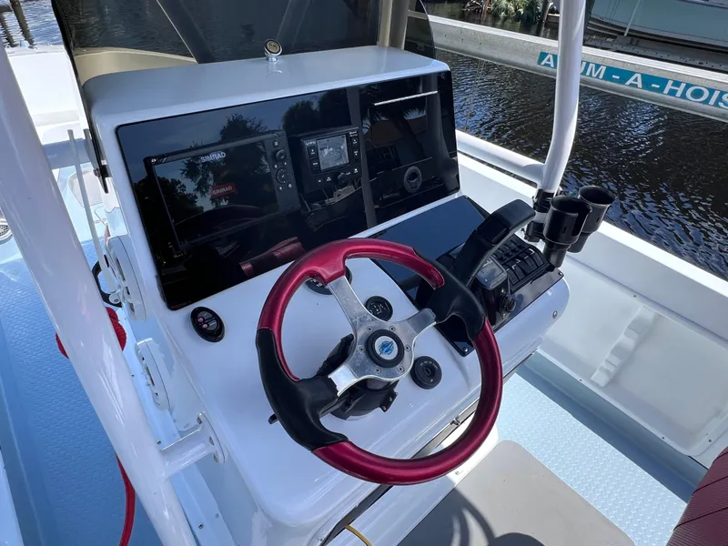 Slide: The Image of Boat cockpit with red steering wheel, modern controls, and navigation screens, Concept 23, year 2000. - 21