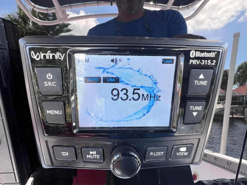 Slide: The Image of Infinity Bluetooth radio display showing 93.5 MHz frequency on a boat dashboard. - 24