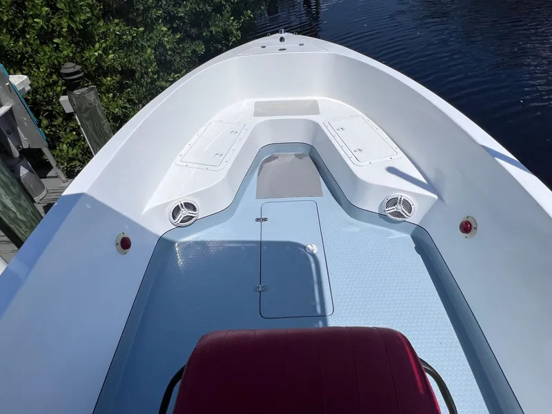 Slide: The Image of Open deck of a 2000 Concept 23 boat, featuring storage compartments and speakers. - 29