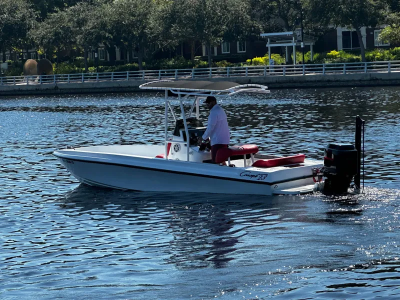 Slide: The Image of Boat on water, Concept 23 model, 2000, with person steering near shoreline. - 3