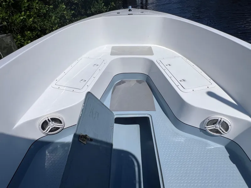 Slide: The Image of Open deck of a 2000 Concept 23 boat with storage compartments and speakers. - 30