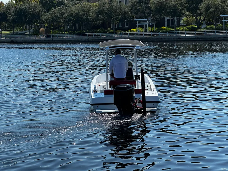 Slide: The Image of Boat on water with person, Concept 23 model, 2000, near shoreline with trees. - 4