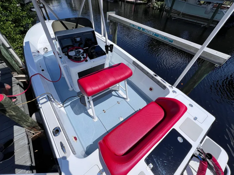 Slide: The Image of Boat interior with red seating, steering console, and water view, Concept 23 model, year 2000. - 6
