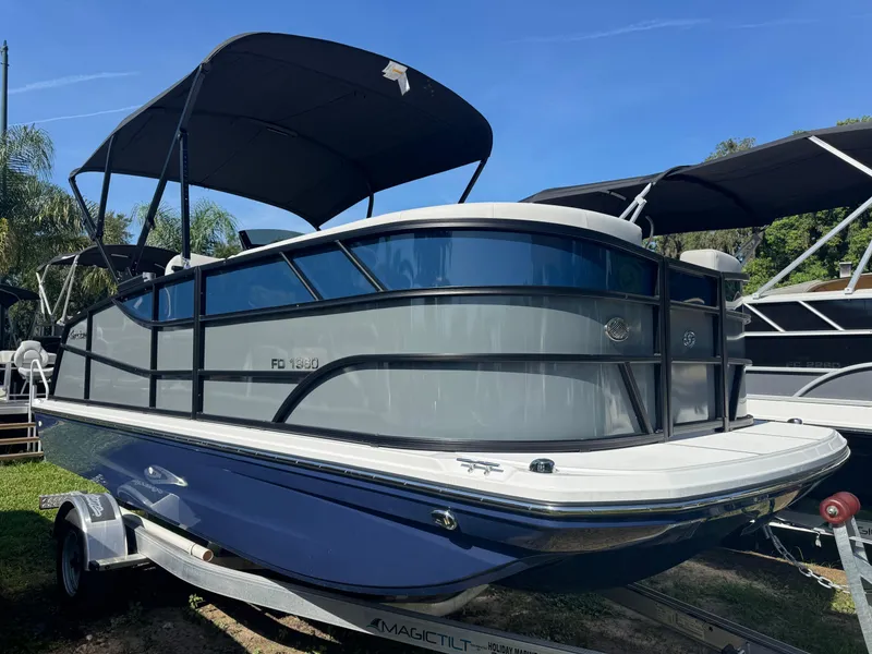 Slide: The Image of 2026 Hurricane FunDeck 1960 RE OB boat on trailer, featuring sleek design and canopy. - 1