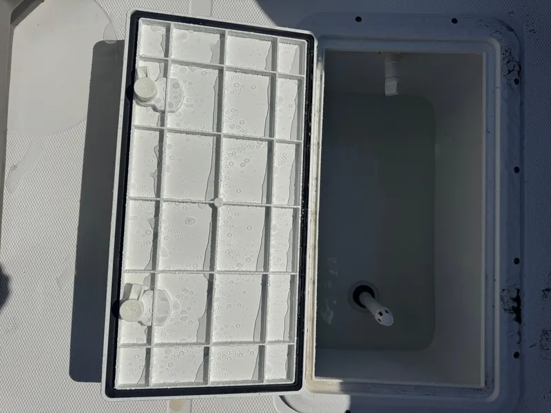 Slide: The Image of Open storage compartment on 2026 Hurricane FunDeck 1960 RE OB boat, showing interior details. - 9
