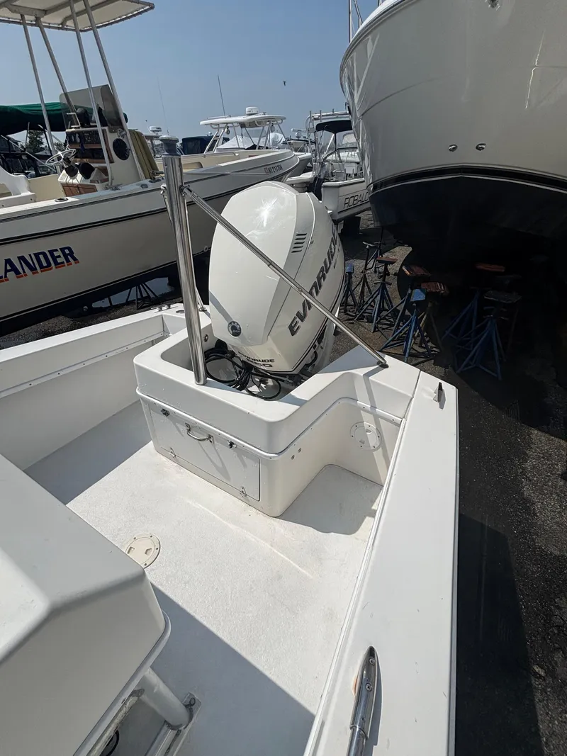 Slide: The Image of 1996 Superboat 24 with Evinrude outboard motor, docked among other boats. - 12