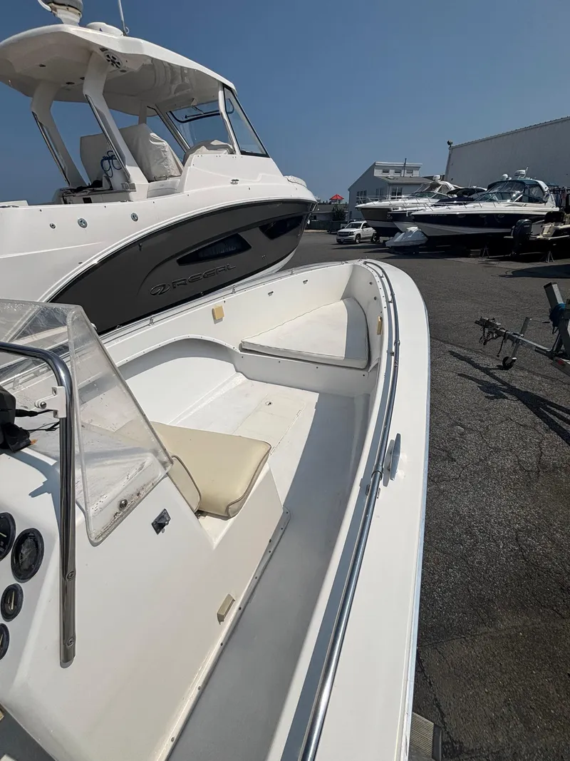 Slide: The Image of 1996 Superboat 24 in a marina, showcasing sleek design and spacious interior. - 15