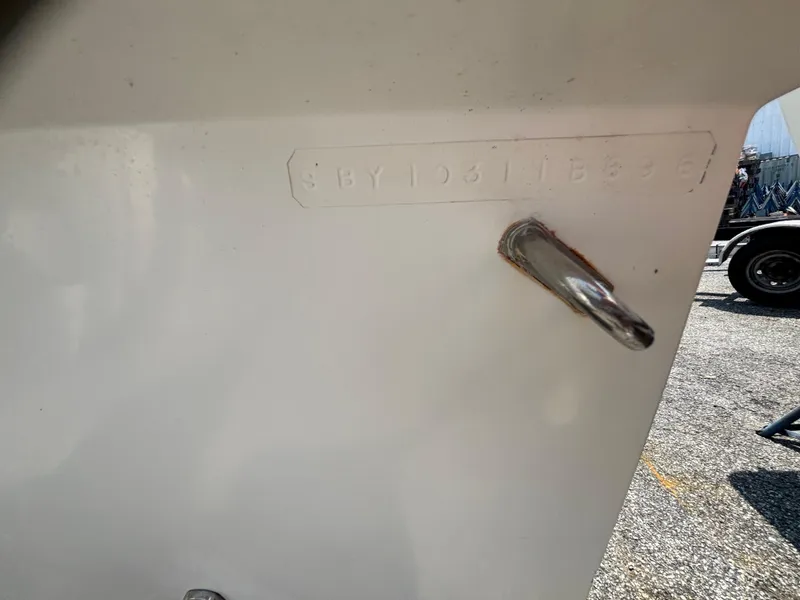 Slide: The Image of 1996 Superboat 24 hull identification number on white surface, outdoor setting. - 19