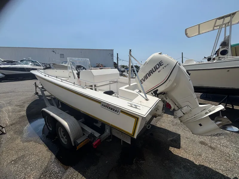 Slide: The Image of 1996 Superboat 24 with Evinrude engine on trailer in boatyard. - 7