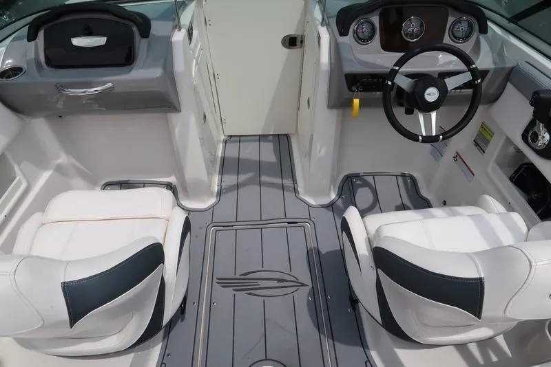 Slide: The Image of 2021 Chaparral 23 SSi boat interior with steering wheel and seating. - 13