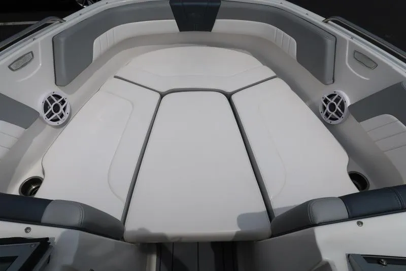 Slide: The Image of 2021 Chaparral 23 SSi boat interior with cushioned seating and speakers. - 21