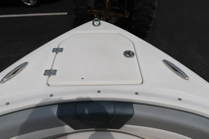 Slide: The Image of 2021 Chaparral 23 SSi boat bow with storage compartment and sleek design. - 24
