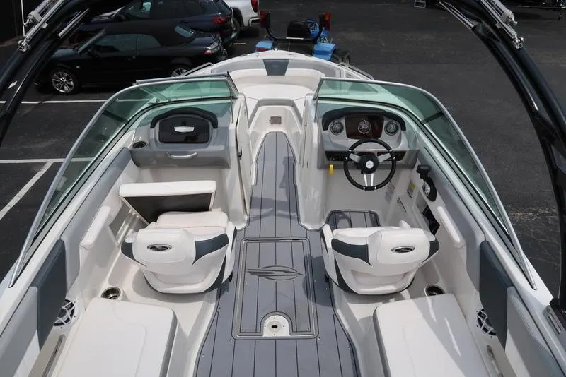 Slide: The Image of 2021 Chaparral 23 SSi boat interior with seating, steering wheel, and dashboard. - 4