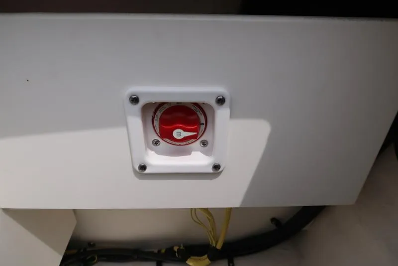 Slide: The Image of Battery switch on a 2021 Chaparral 23 SSi boat, mounted on a white panel. - 9