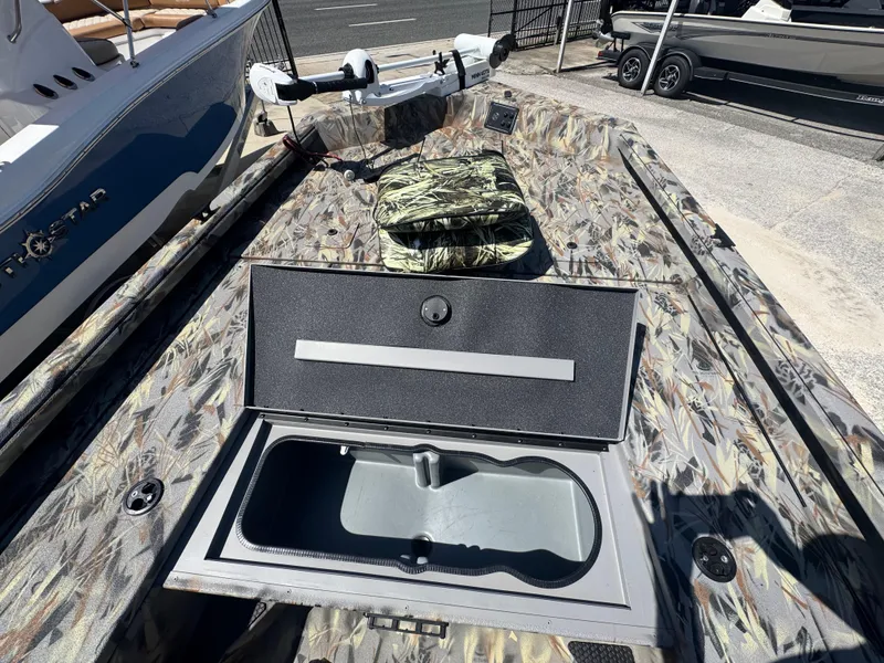Slide: The Image of 2025 Ranger RB210 boat with open storage compartment and camouflage design. - 10