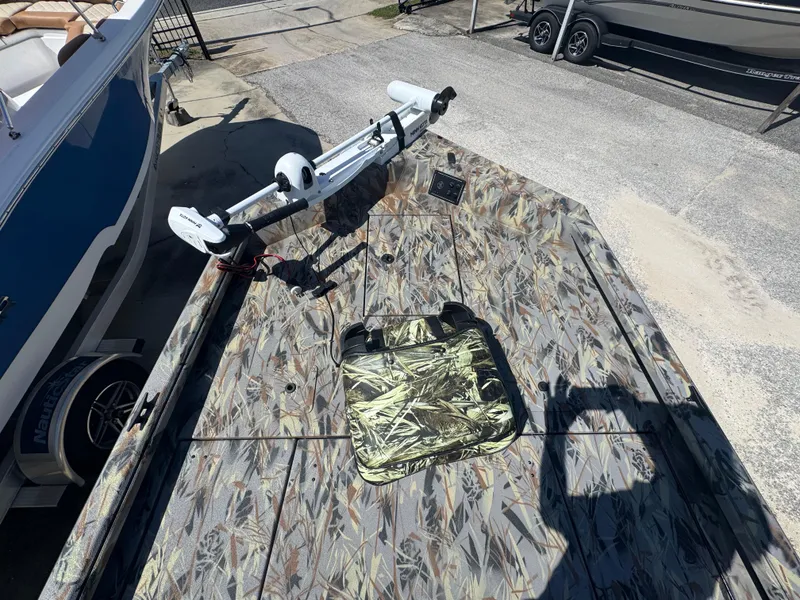 Slide: The Image of Camouflage-patterned deck of 2025 Ranger RB210 boat with mounted trolling motor. - 12