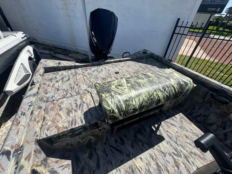 Slide: The Image of 2025 Ranger RB210 boat with camouflage design, featuring a powerful outboard motor. - 4