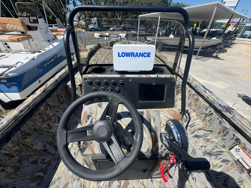 Slide: The Image of Interior view of 2025 Ranger RB210 boat with steering wheel and Lowrance navigation system. - 6