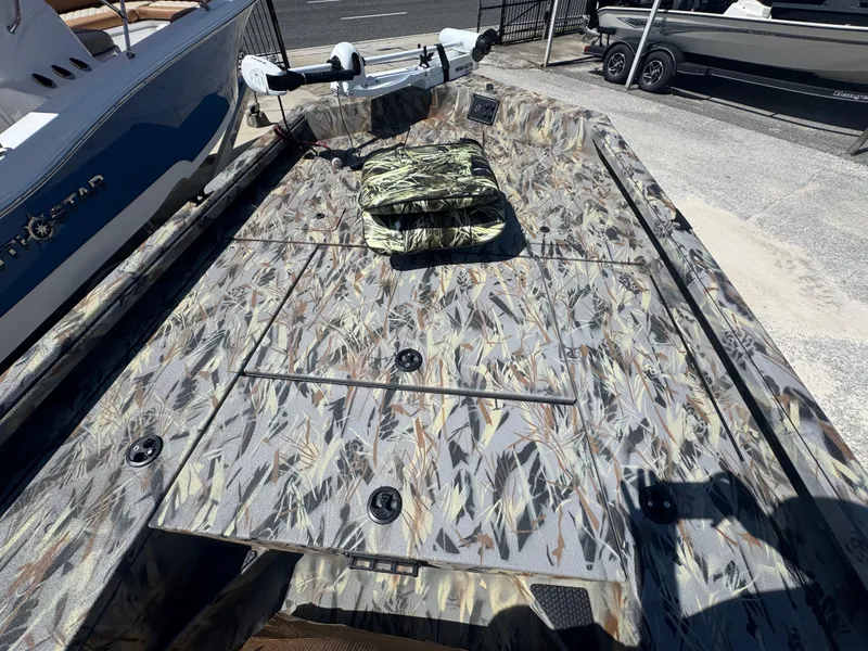 Slide: The Image of 2025 Ranger RB210 boat with camouflage deck pattern, featuring a trolling motor and storage compartments. - 9