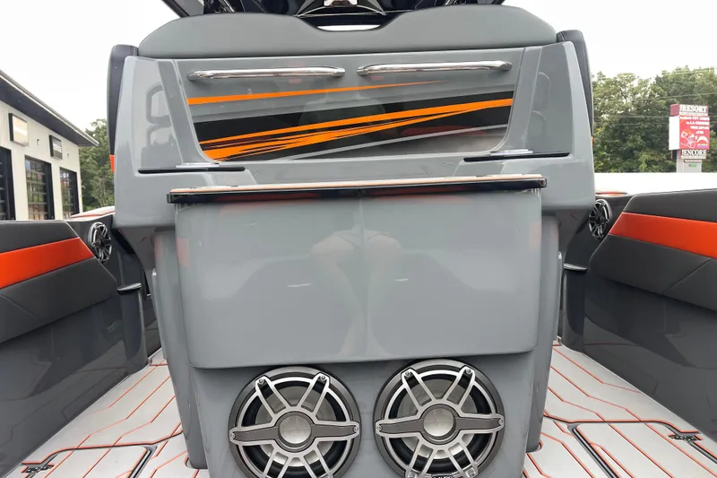 Slide: The Image of 2025 Sunsation 32 CCX boat interior with sleek design, vibrant orange accents, and modern speakers. - 14