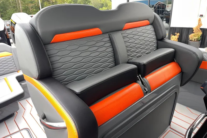 Slide: The Image of 2025 Sunsation 32 CCX boat seat with sleek black and orange design. - 18