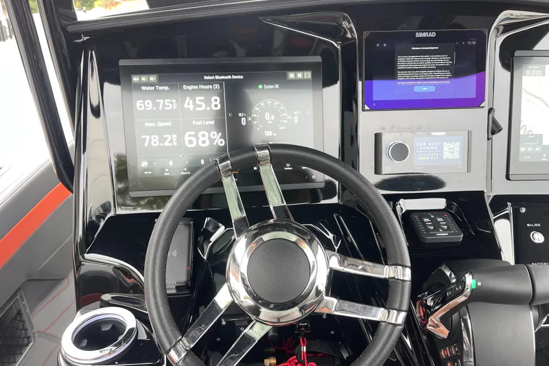 Slide: The Image of Dashboard of 2025 Sunsation 32 CCX boat with digital displays and steering wheel. - 19