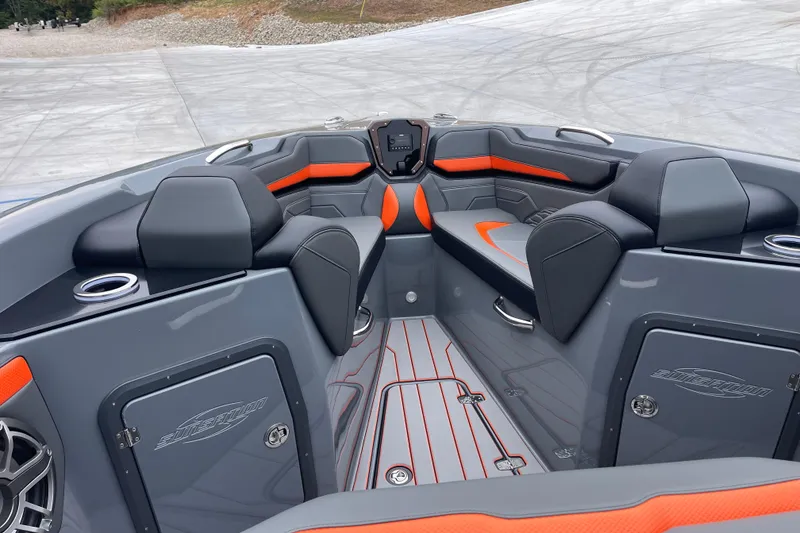 Slide: The Image of 2025 Sunsation 32 CCX boat interior with sleek gray and orange seating design. - 24