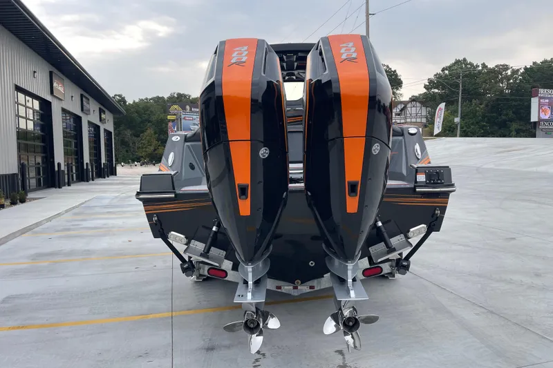 Slide: The Image of 2025 Sunsation 32 CCX boat with dual 400R engines, parked outside a modern building. - 5